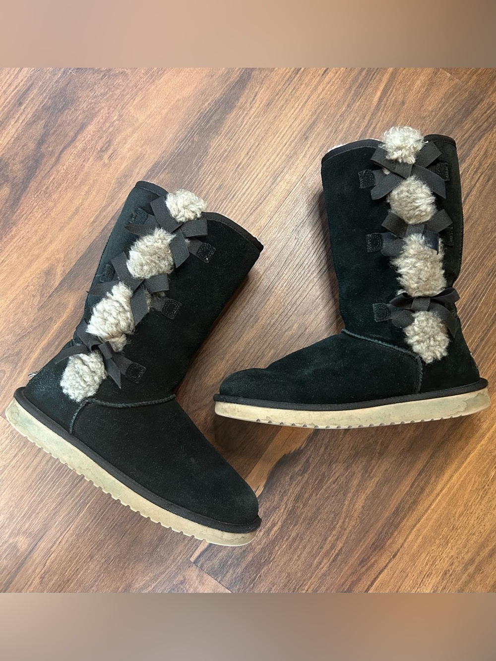 UGG Black Suede Pom Pom Mid-Calf Winter Boots with Bow Accents